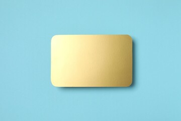 Golden paper card on color background