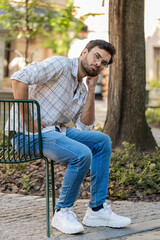 Tired sad Indian man feeling worried about financial problem stress outdoors. Arabian Hindu guy...