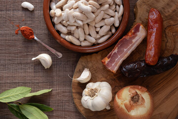 Ingredients for preparing traditional Asturian fabada on wooden table