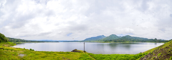 panoramic view of beautiful mountain lake under cloudy sky. Wadas lintang lake located in Indonesia