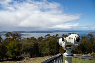tower viewer lookout telescope over a forest and beach ocean in australia