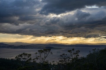 Naklejka premium dawn golden sunrise over hobart over the ocean