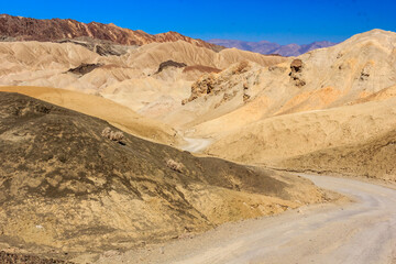 A road winds through a desert landscape