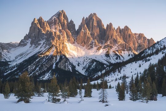 A photo of a breathtaking winter landscape with towering, jagged mountain peaks