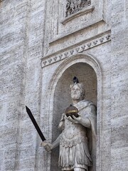 a pigeon on the head of a statue