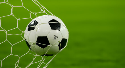 soccer ball in goal with green background
