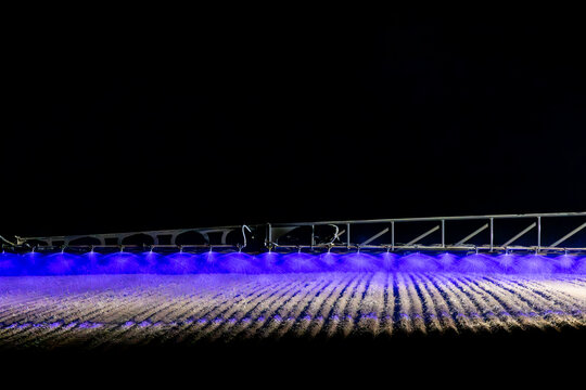 Self propelled boom sprayer spraying herbicide after planting canola