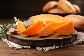 Sliced sweet potato on wooden table, closeup