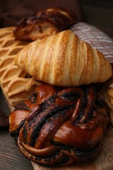 Different sweet pastries on wooden table, closeup