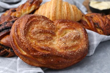 Different delicious pastries on grey table, closeup