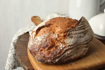 Freshly baked bread on wooden table, closeup