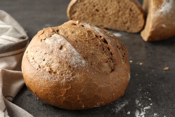 Freshly baked bread on grey table, closeup