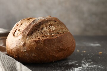 Freshly baked bread on grey table, closeup. Space for text