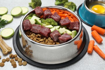 Dry pet food and natural products on light table, closeup