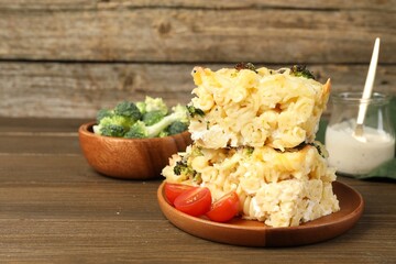 Tasty pasta casserole with cheese and broccoli served on wooden table