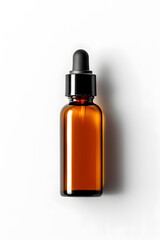 Fototapeta premium Amber glass dropper bottle with black cap mock up isolated on white background