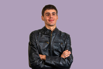 Young musician smiling with folded arms wearing black leather jacket