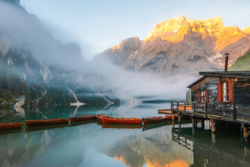 Lago di Braies or Pragser Wildsee lake with boats and fishing dock.Fanes-Sennes-Braies national...