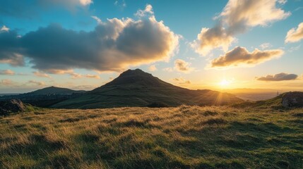 Sunset over grassy hilltop, city skyline background, landscape photography