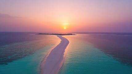 Aerial shot of a long sandy beach bordered by turquoise water under a glowing sunset.