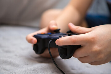 boy's hands with gamepad close up © toomler