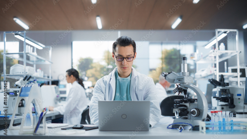 Poster Genetic Research Scientist Working on a Laptop Computer in an Applied Science Laboratory. Portrait of a Handsome Young Multiethnic Lab Engineer in White Coat at Work