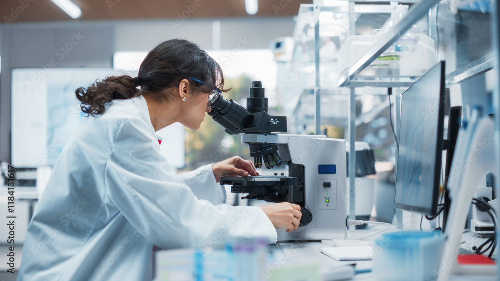 Aufkleber Portrait of a Beautiful Caucasian Student Working on a Research Project in College. Medical Research Scientist Looking at Biological Samples Under a Microscope in an Applied Science Laboratory