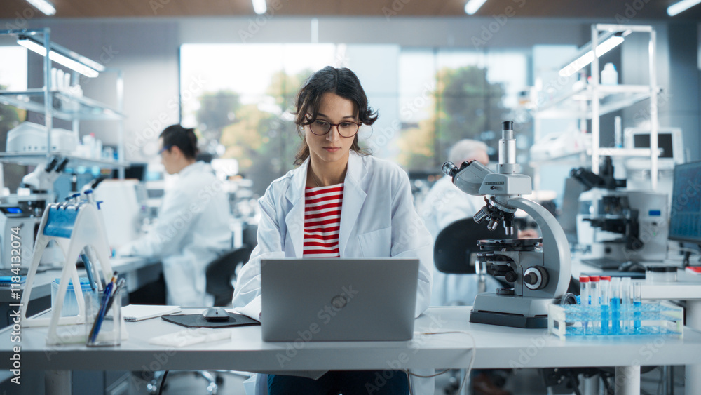 Poster portrait of a smart female student working on laptop on a research project in school. medical resear