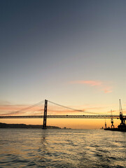 Sunset over the 25 de Abril Bridge in Lisbon, Portugal,