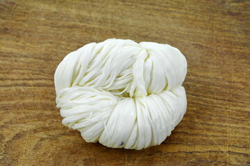 Arabian white string cheese on wooden table