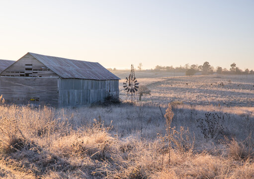 A broken windmill, an old shed and a winter's morning