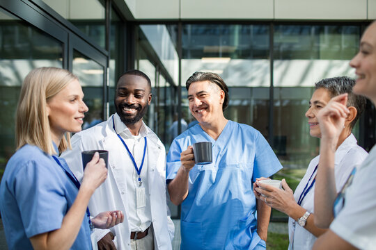 Healthcare professionals enjoying coffee break outside hospital