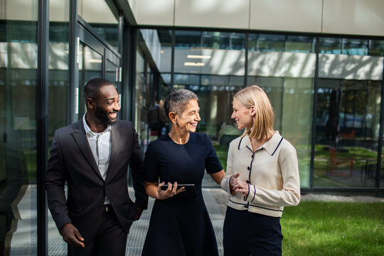 Business team having a discussion outside modern office building