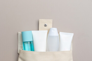 Multi-colored beauty bottles and cosmetics styled elegantly in a flat lay composition.