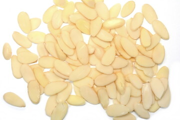 Heap of raw almond flakes isolated on white background. Sliced almonds pile.  Peeled or hulled...