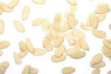 Heap of raw almond flakes isolated on white background. Sliced almonds pile.  Peeled or hulled almond slices pile isolated.