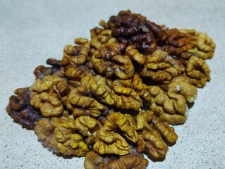 Shelled healthy nuts on a gray background. Food and nut fruit theme.