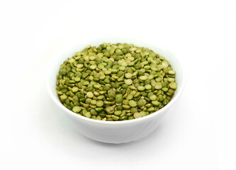 Pile of dried green split peas in a white bowl isolated on white.