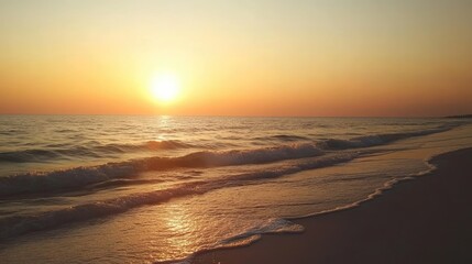 Fototapeta premium Sunset colors blending over the horizon, with waves breaking softly on the shore.