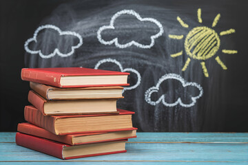 Red books, chalkboard sun, and clouds vibrant learning themed composition