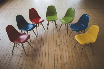 Colorful chairs in semicircle vibrant, inclusive community setting