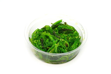 Heap of organic Japanese Wakame salad isolated on white background. Edible Green Algae, Sea Vegetable Isolated. Green Chuka Seaweed Salad Isolated on White Background. Edible Seaweed 