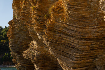 layered rocks of the sea cliff in Budva.
