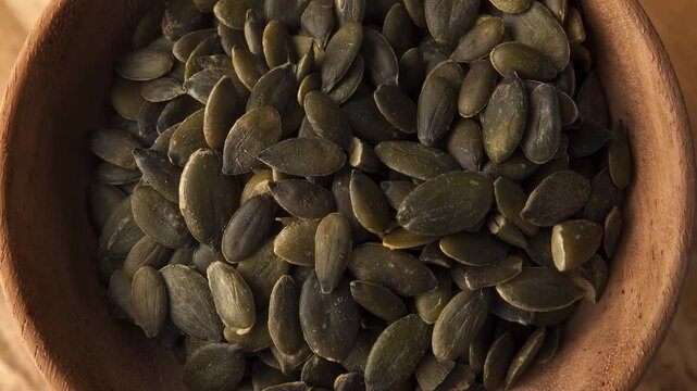 Heap od pumpkin seeds close up slowly rotating professional stock footage
