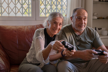 Older couple sharing a fun time playing on the PlayStation