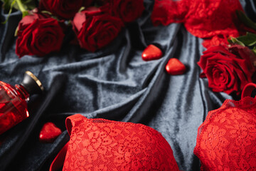 Romantic dating. Valentine's day, lace women's red underwear, lingerie, massage oil and red roses...
