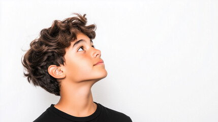 Hispanic teenage boy around 14 years old with medium-length wavy hair, looking skeptical in profile on the right side of photo on white removable background.