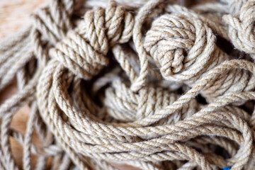 Close-up of natural hemp ropes, neatly coiled and designed for artistic and secure bondage, showcasing their texture and organic material.