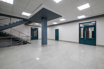 panorama view in empty modern hall with columns, doors and panoramic windows at night