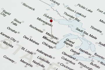 Macro photo of red pin needle into Madison city of United States of America political map 